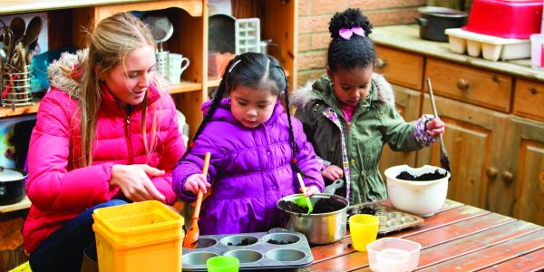 Children playing with kitchen utensils outdoors