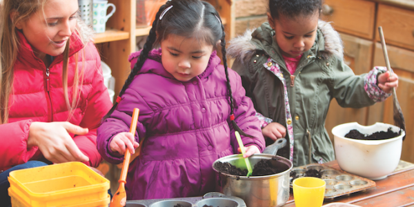 Teacher and students with mud kitchen