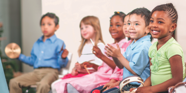 Children playing with musical instruments in class