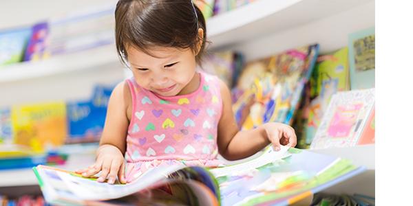 young child reading a picture book