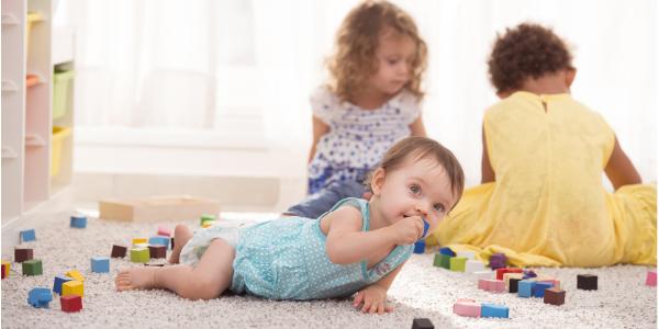 Group of toddlers playing with blocks on the floor