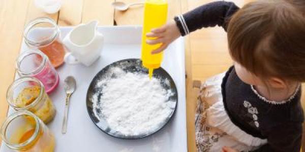 Young child experimenting with various materials