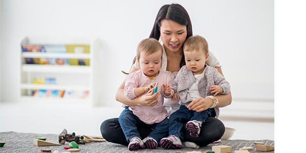 a parent holding two children