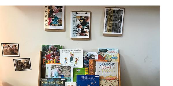 A bookshelf with children's books, some of which the children created.