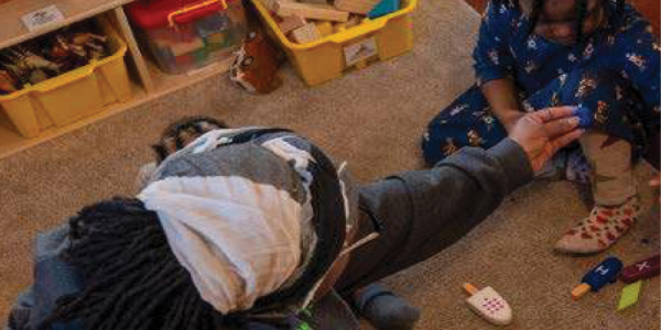 An adult playing with a child