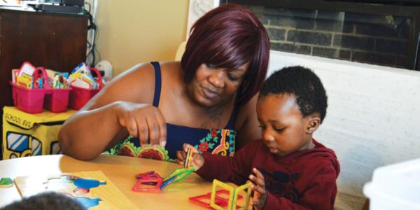 Teacher helping student build structure