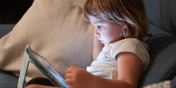 Preschool girl watching a digital tablet