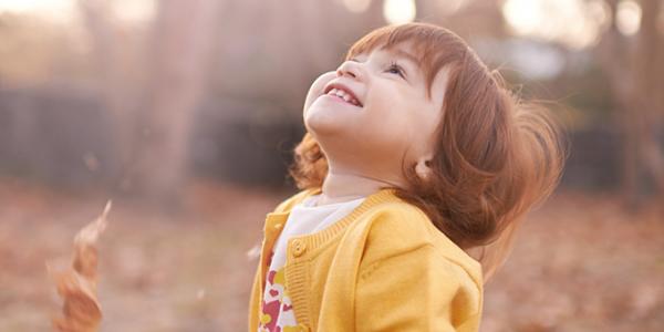 Toddler outside looking up at sky