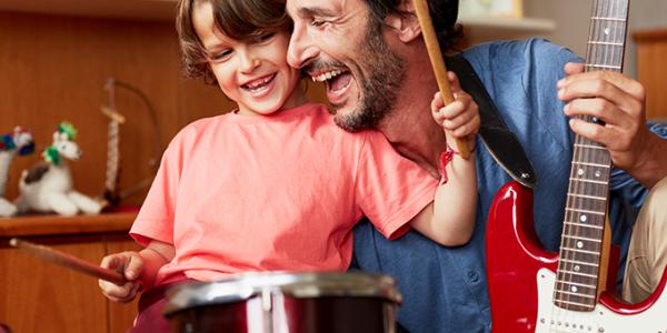 Father and son playing drums and guitar