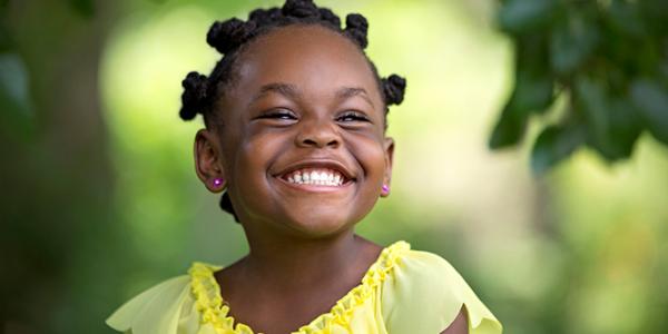 Preschool girl smiling outside