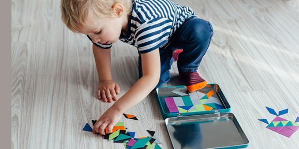 Young boy playing with shapes on the ground