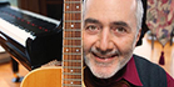 Raffi holding a guitar