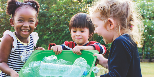 Three children with recycling bin