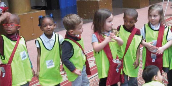 Line of small children wearing safety vests