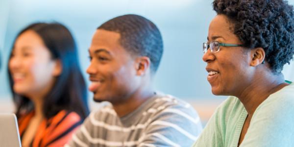 Three students in a higher education classroom