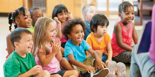 Preschool students sitting on floor