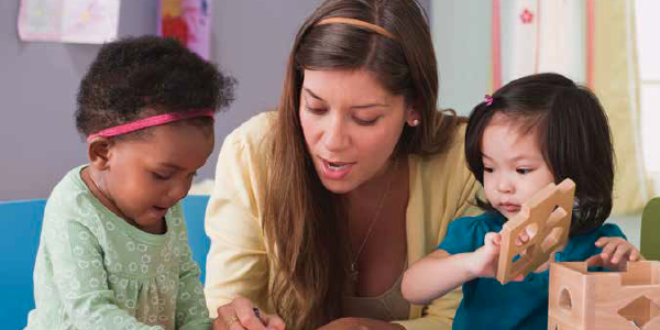 Teacher helping two students 