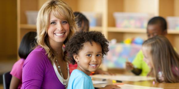 Teacher sitting with preschooler