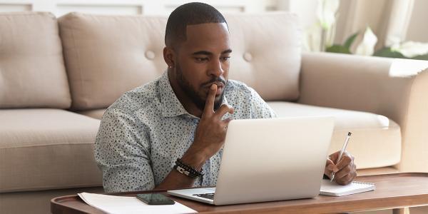 man at a laptop reading the screen