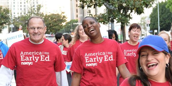 A group of early education advocates walking down the street