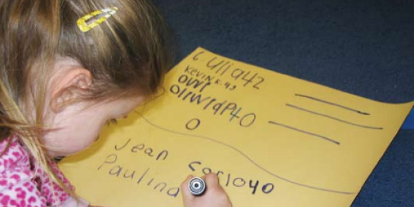 Child writing on poster