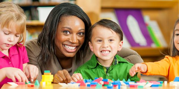 Preschool children and teacher sorting shapes