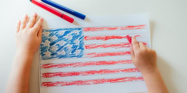 child drawing an american flag