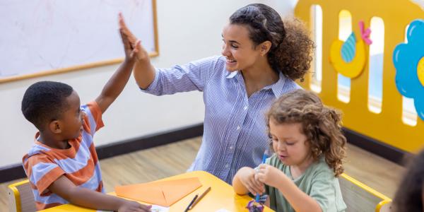 a teacher giving a child a high five