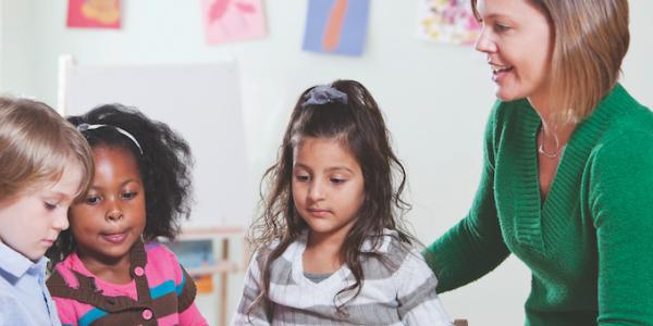 Teacher observing three students 