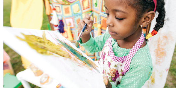 Girl painting on a canvas