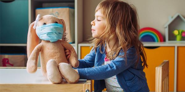 child playing covid with stuffed animal