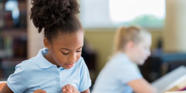 A young child reading a book.