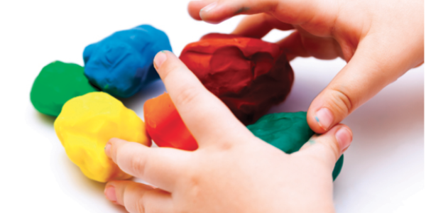 A child's hands with playdough.