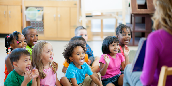 A group of children listening to their teacher.