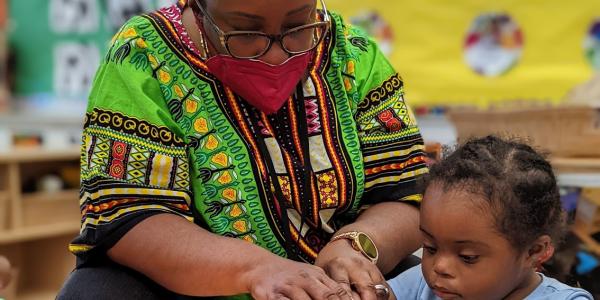 a teacher guiding a child through play