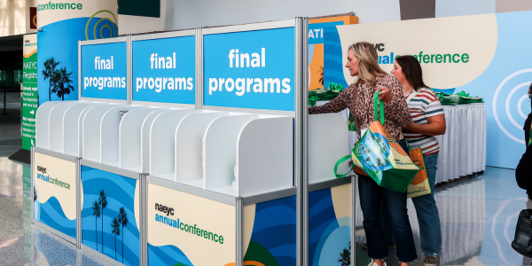 Attendee grabbing a conference program