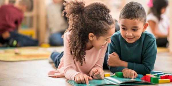 two children on the floor reading