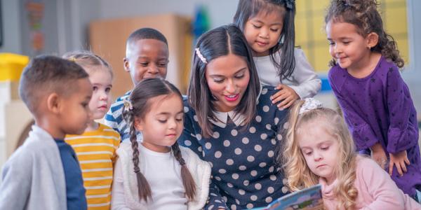 Image of a teacher reading to a group of students