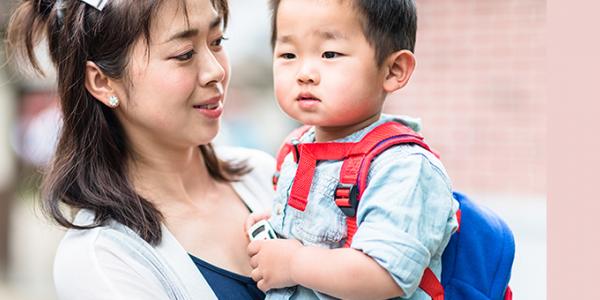 Mother holding her son at school