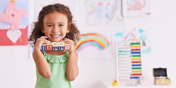 Girl smiling with toys