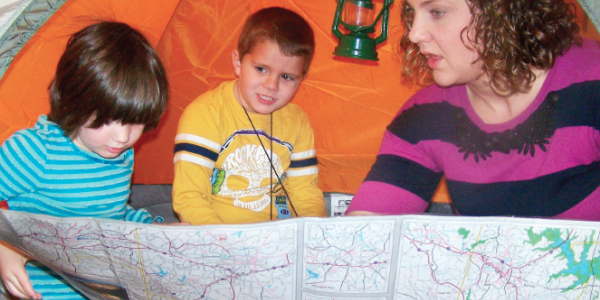 Teacher and students in tent