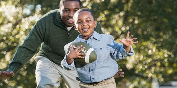 Father and son playing football