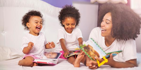 Mother reading with toddler girls