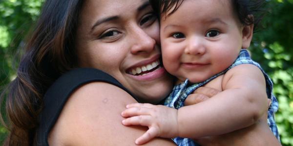 Mother holding her infant son