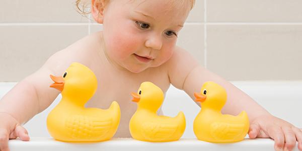 Child playing with rubber ducks