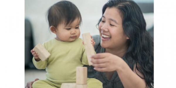 Infant and mother playing with blocks