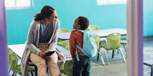 A teacher converses with her student.