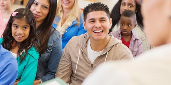 Adults and children in a learning environment.