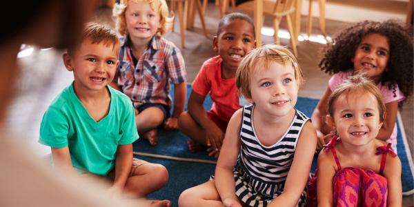 Children gathered on the play mate.