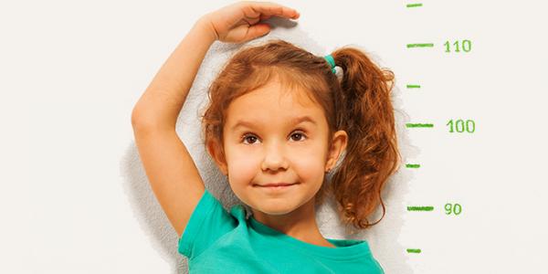 Preschool girl measuring her height